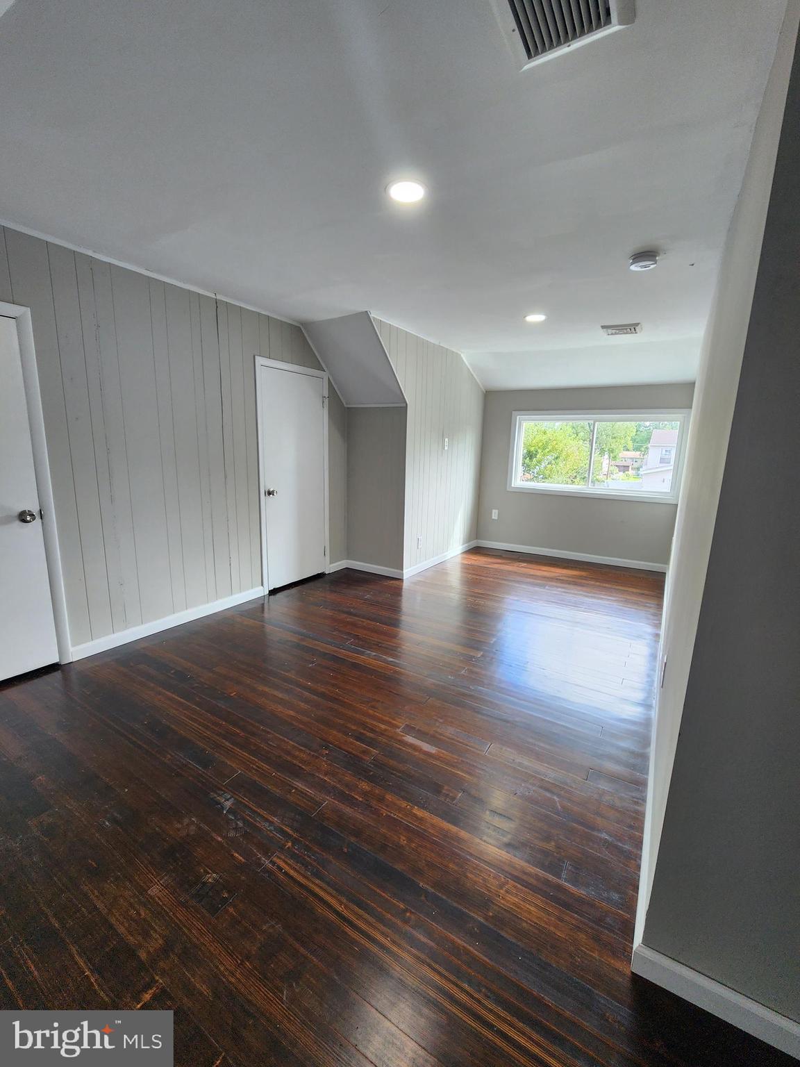 10 Webster Avenue Stratford, NJ 08084 - Photo 7 of 20 an empty room with wooden floor and windows