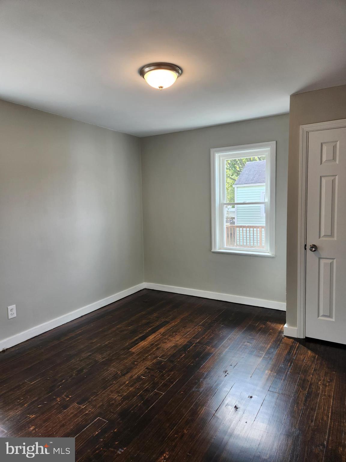 10 Webster Avenue Stratford, NJ 08084 - Photo 8 of 20 a view of an empty room with wooden floor and a window