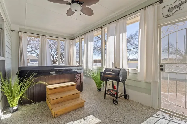 a living room with furniture and floor to ceiling windows