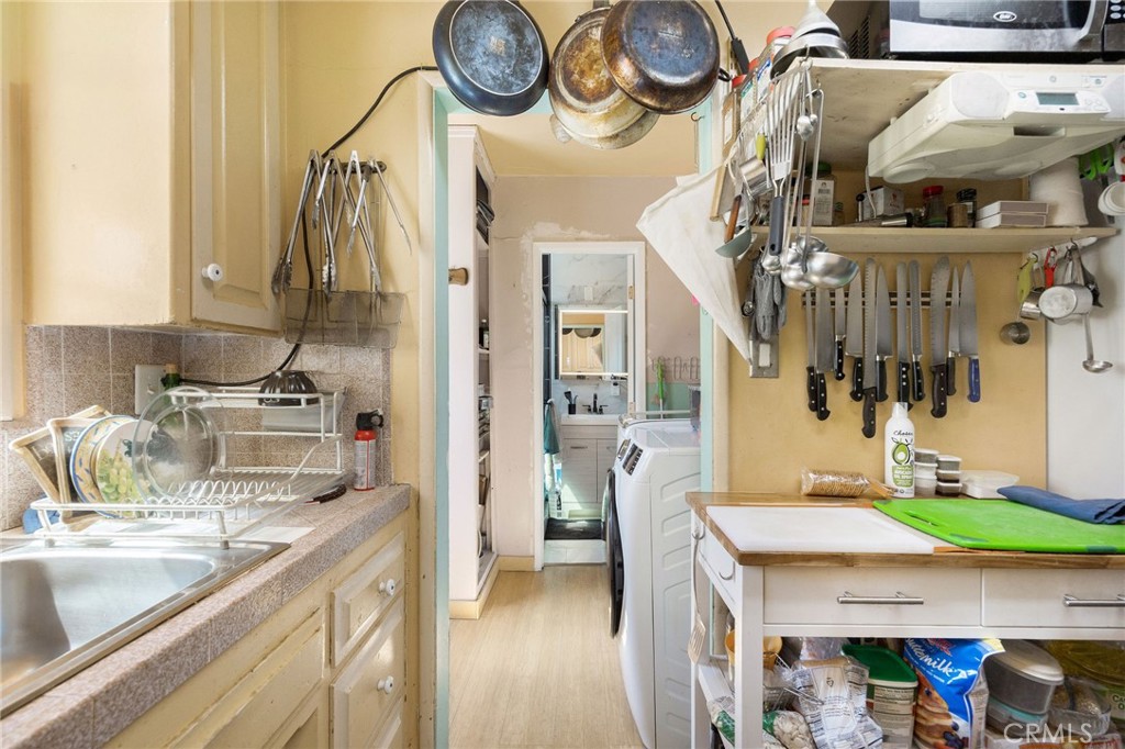 2905 Rindge Lane Redondo Beach, CA 90278 - Photo 7 of 26 a kitchen with a sink a stove top oven a clock and a window