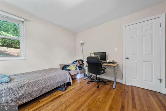 a bedroom with a bed and a desk