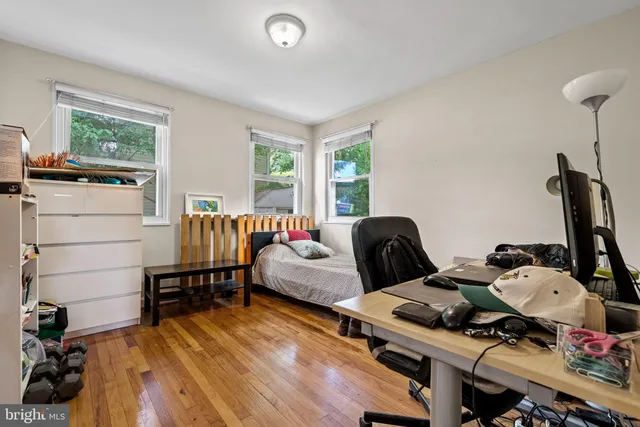 a bedroom with furniture and a wooden floor