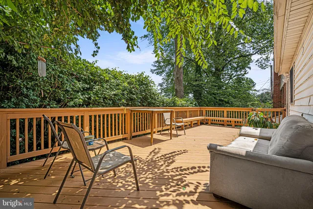 a balcony with wooden floor and fence