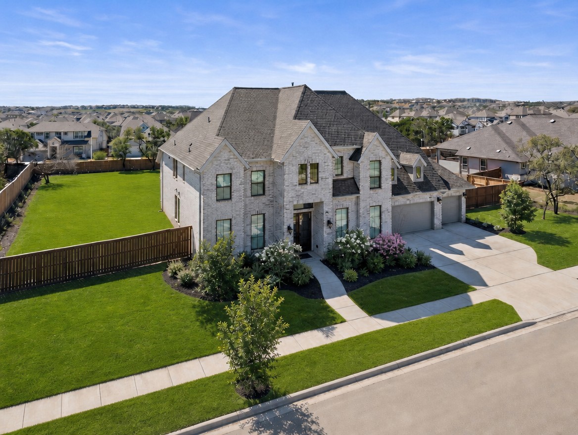 1440 Riva Ridge Drive Leander, TX 78641 - Photo 2 of 37 A spacious suburban home with well-kept landscaping, offering generous outdoor living space and ample parking.