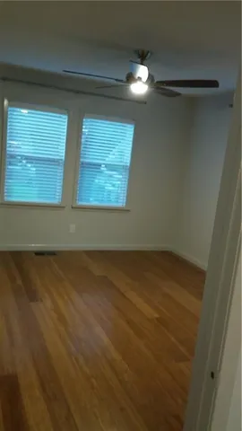 a view of a small space with wooden floor and a window