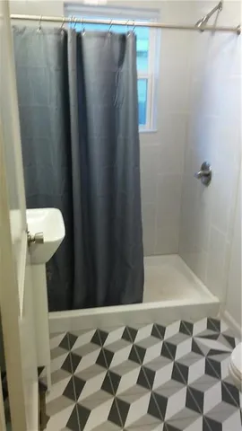 a bathroom with a shower and a sink