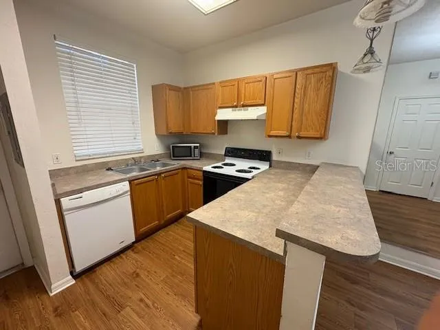 an empty room with fan and entrance