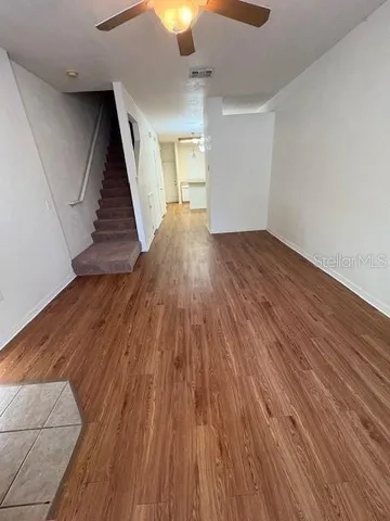 wooden floor in an empty room with a window