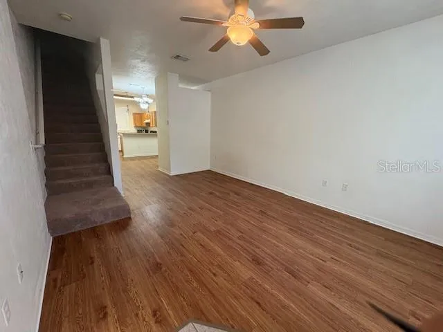 a view of a kitchen with a sink dishwasher a refrigerator and wooden floor