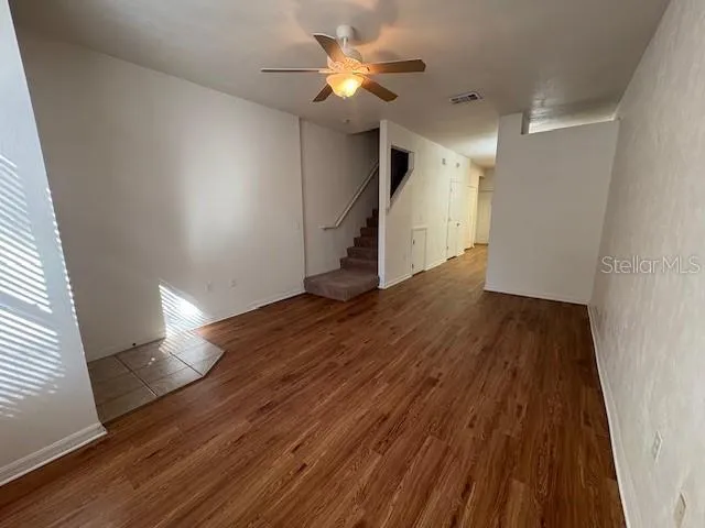 a view of storage and utility room with wooden floor