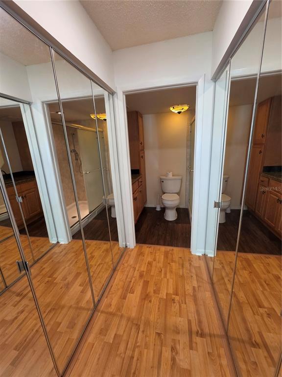 1281 Pine Ridge Circle East, Unit B1 Tarpon Springs, FL 34688 - Photo 11 of 30 a bedroom with a bed and a large mirror