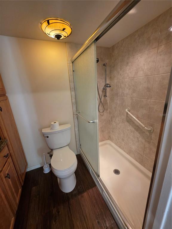 1281 Pine Ridge Circle East, Unit B1 Tarpon Springs, FL 34688 - Photo 12 of 30 a bathroom with a toilet and a shower