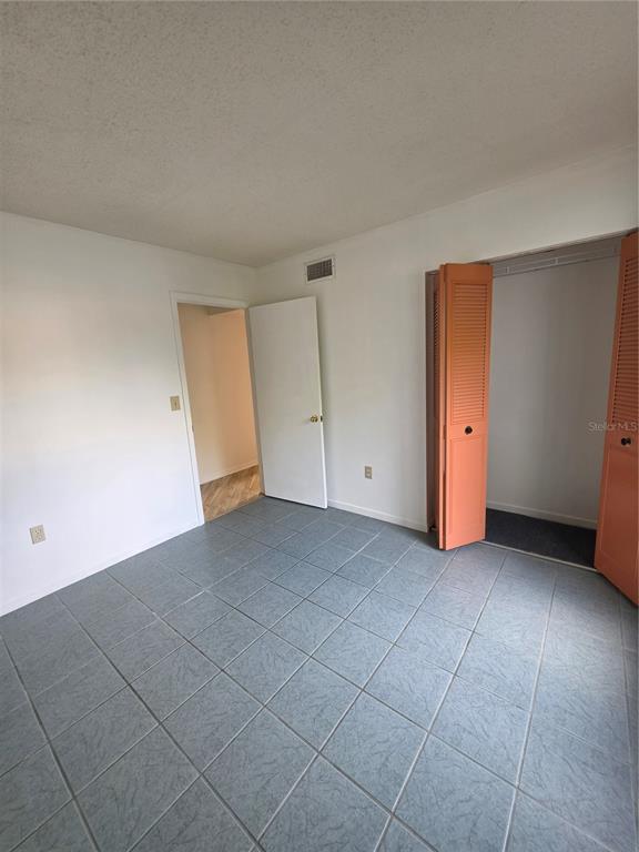 1281 Pine Ridge Circle East, Unit B1 Tarpon Springs, FL 34688 - Photo 14 of 30 an empty room with a natural light