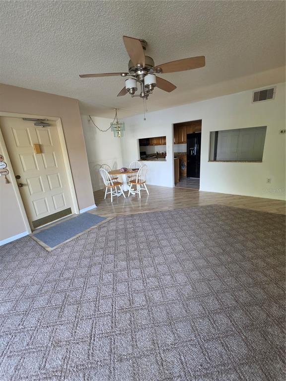1281 Pine Ridge Circle East, Unit B1 Tarpon Springs, FL 34688 - Photo 17 of 30 a view of livingroom with furniture chandelier fan and fireplace
