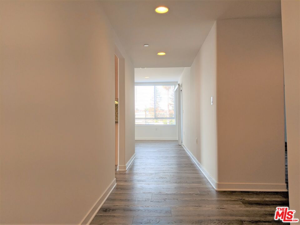 5143 White Oak Avenue, Unit 306 Encino, CA 91316 - Photo 13 of 32 a view of a hallway with wooden floor