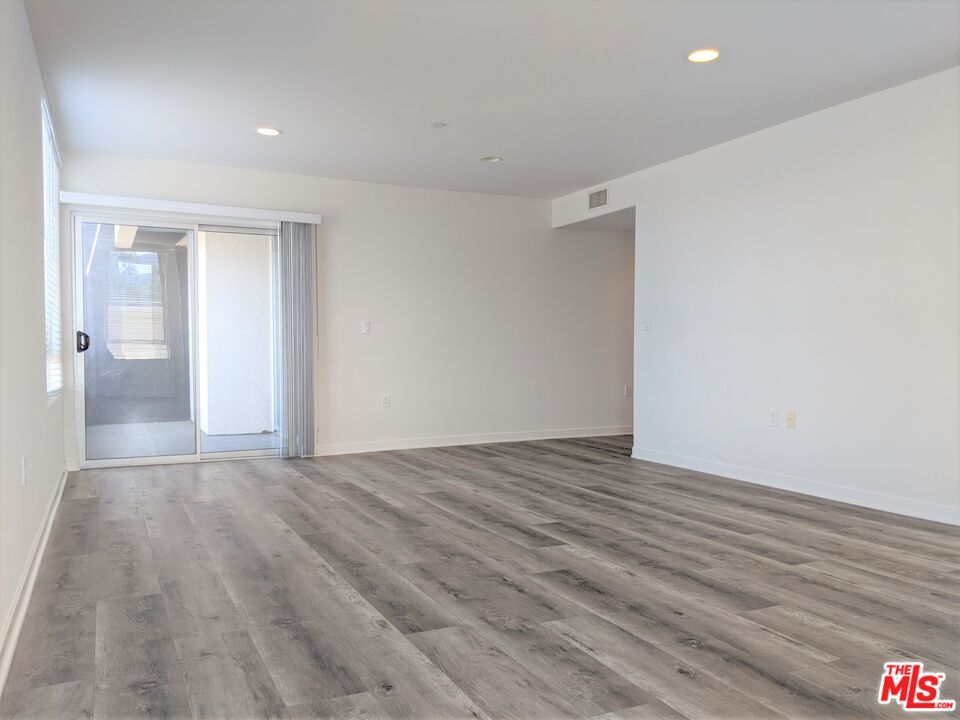 5143 White Oak Avenue, Unit 306 Encino, CA 91316 - Photo 14 of 32 a view of an empty room with wooden floor and a bathroom