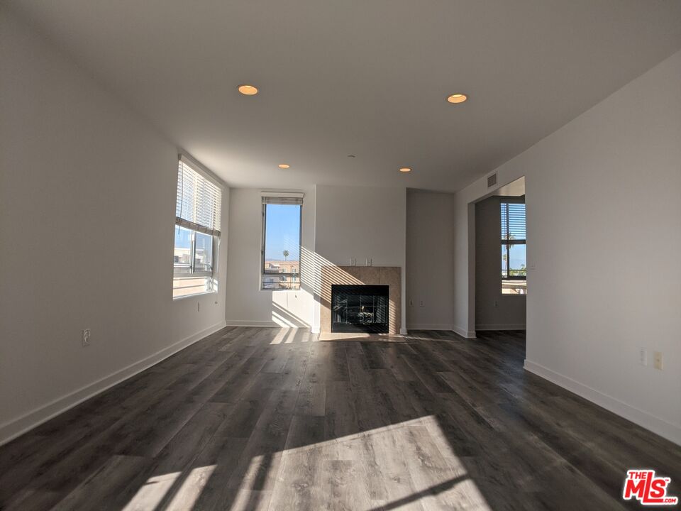 5143 White Oak Avenue, Unit 306 Encino, CA 91316 - Photo 15 of 32 a view of empty room with fireplace and wooden floor