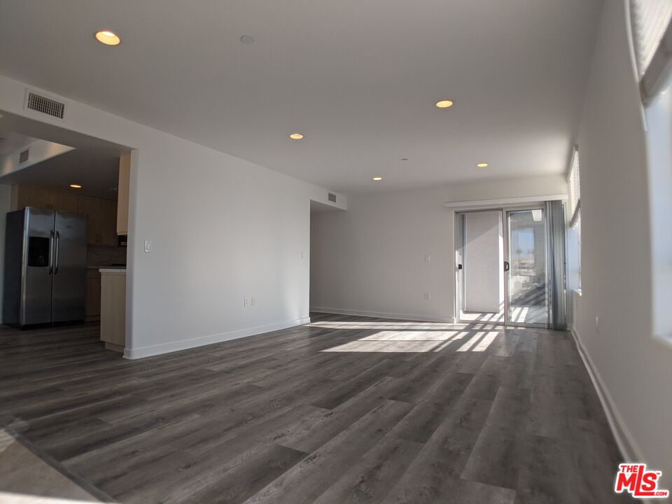 5143 White Oak Avenue, Unit 306 Encino, CA 91316 - Photo 17 of 32 an empty room with wooden floor and entrance