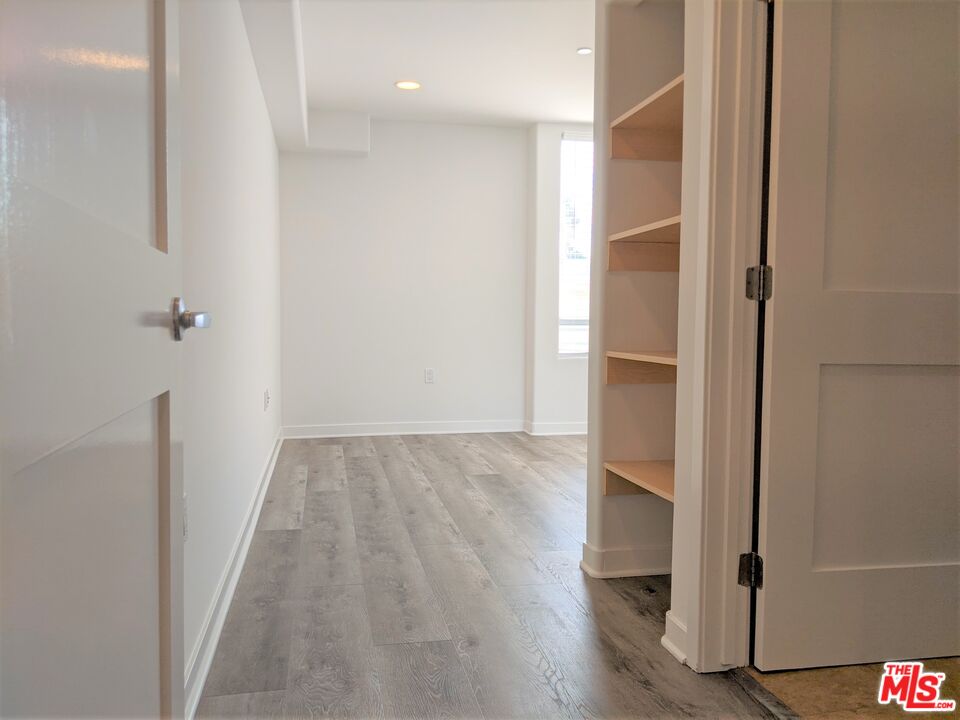 5143 White Oak Avenue, Unit 306 Encino, CA 91316 - Photo 22 of 32 a view of hallway with wooden floor