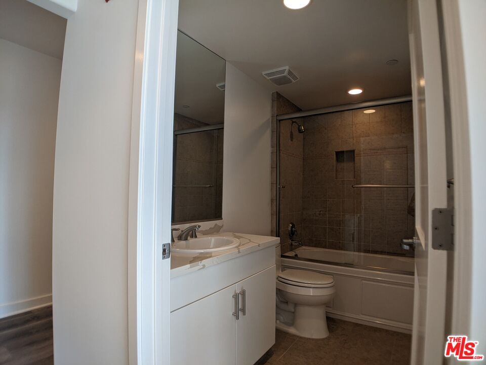 5143 White Oak Avenue, Unit 306 Encino, CA 91316 - Photo 23 of 32 a bathroom with a granite countertop sink toilet and shower