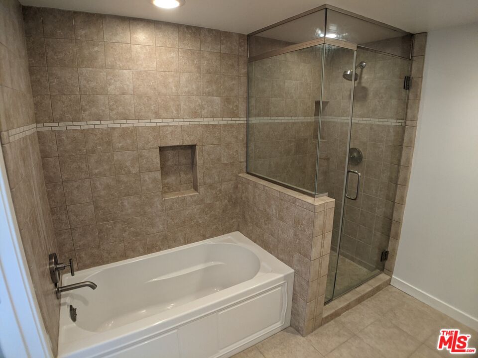 5143 White Oak Avenue, Unit 306 Encino, CA 91316 - Photo 31 of 32 a bathroom with a shower and a bath tub