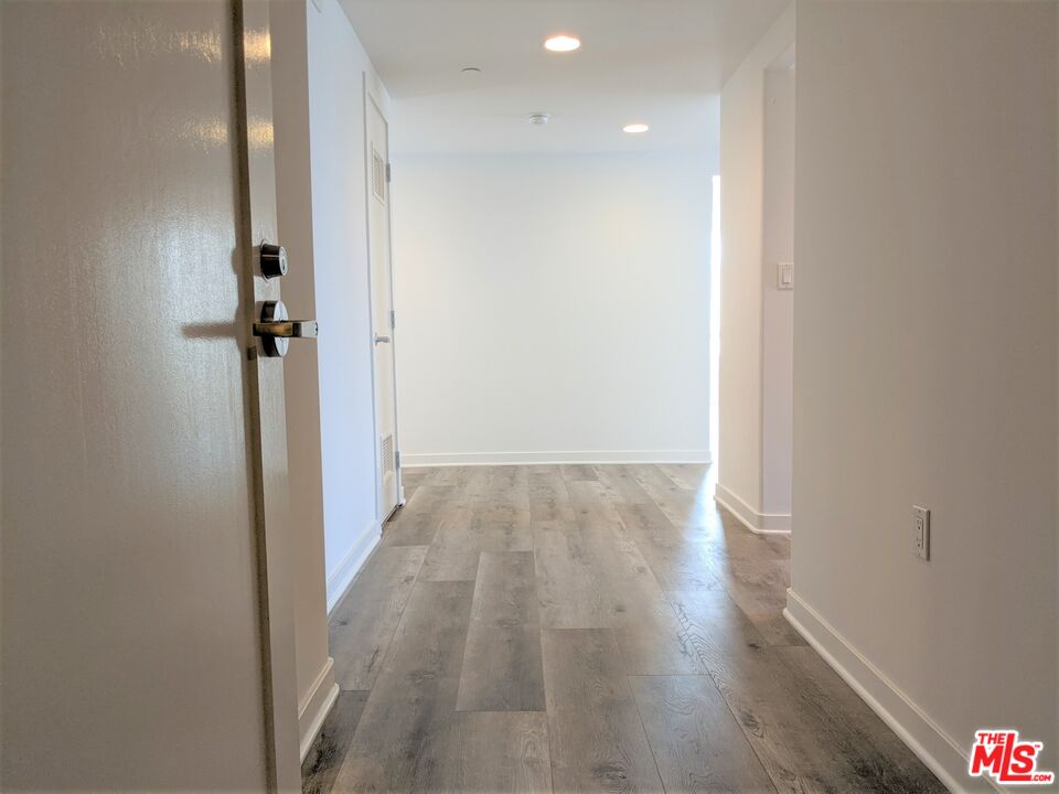 5143 White Oak Avenue, Unit 306 Encino, CA 91316 - Photo 6 of 32 a view of a hallway with wooden floor