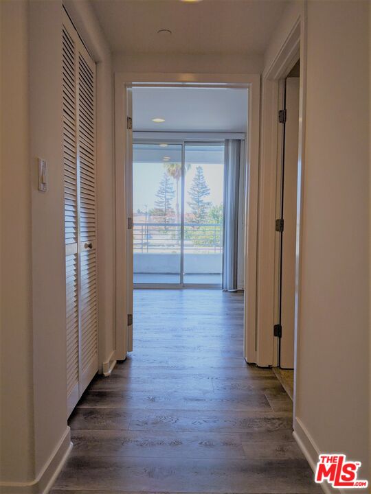 5143 White Oak Avenue, Unit 306 Encino, CA 91316 - Photo 9 of 32 a view of a hallway with wooden floor and front door