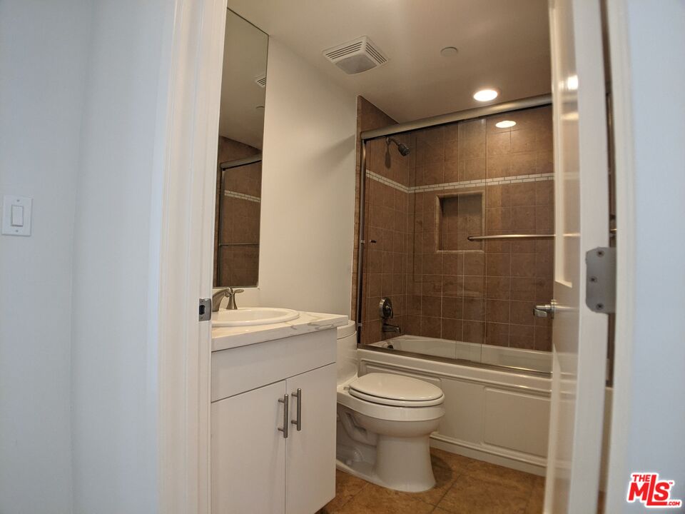 5143 White Oak Avenue, Unit 306 Encino, CA 91316 - Photo 10 of 32 a bathroom with a sink a toilet and shower