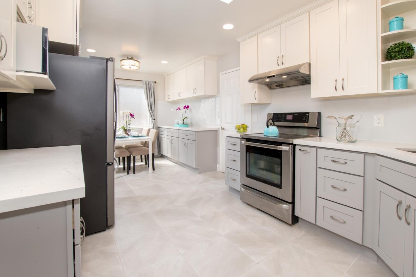 3416 Tracy Drive Santa Clara, CA 95051 - Photo 9 of 26 a kitchen with stainless steel appliances a stove a sink and white cabinets