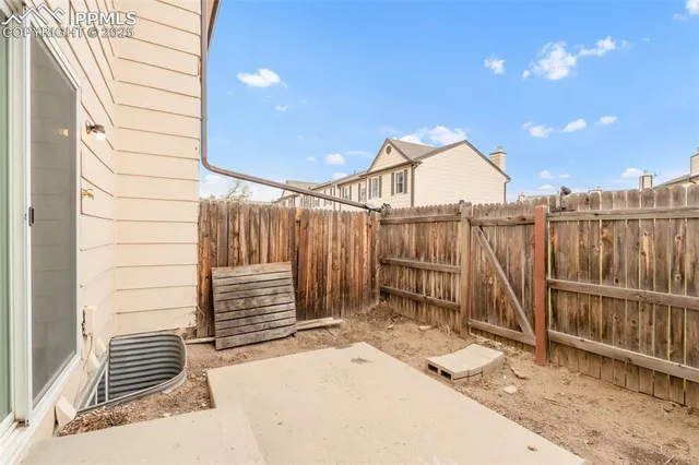 an aerial view of a house with swimming pool and a yard