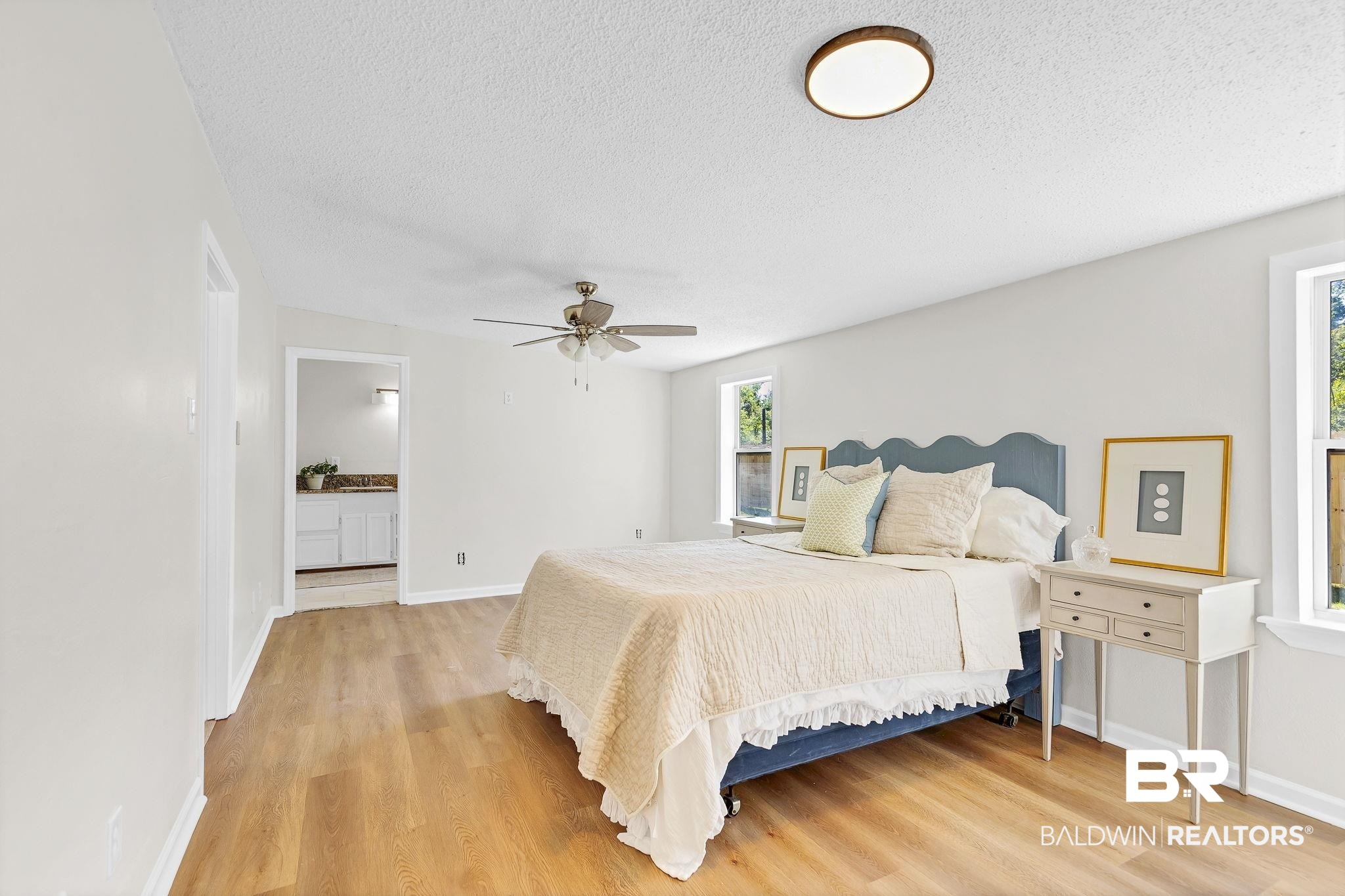 11964 Stroh Road Daphne, AL 36527 - Photo 37 of 58 Bedroom with baseboards, a ceiling fan, light wood-style floors, and a textured ceiling