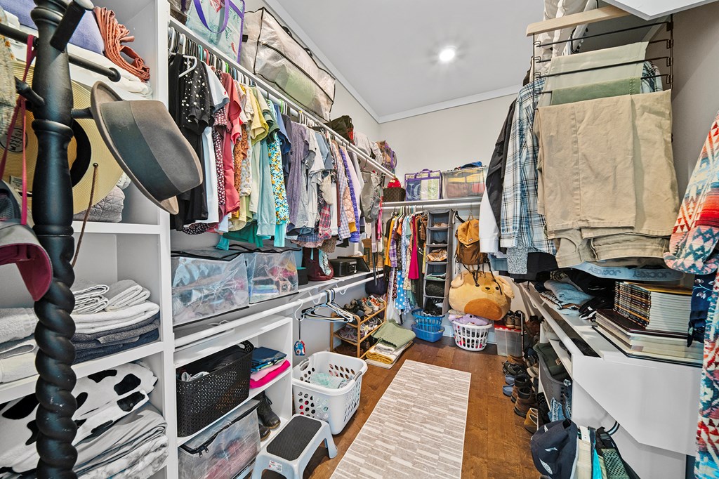 392 London Road Ball Ground, GA 30107 - Photo 10 of 60 a view of walk in closet with clothes and shoes