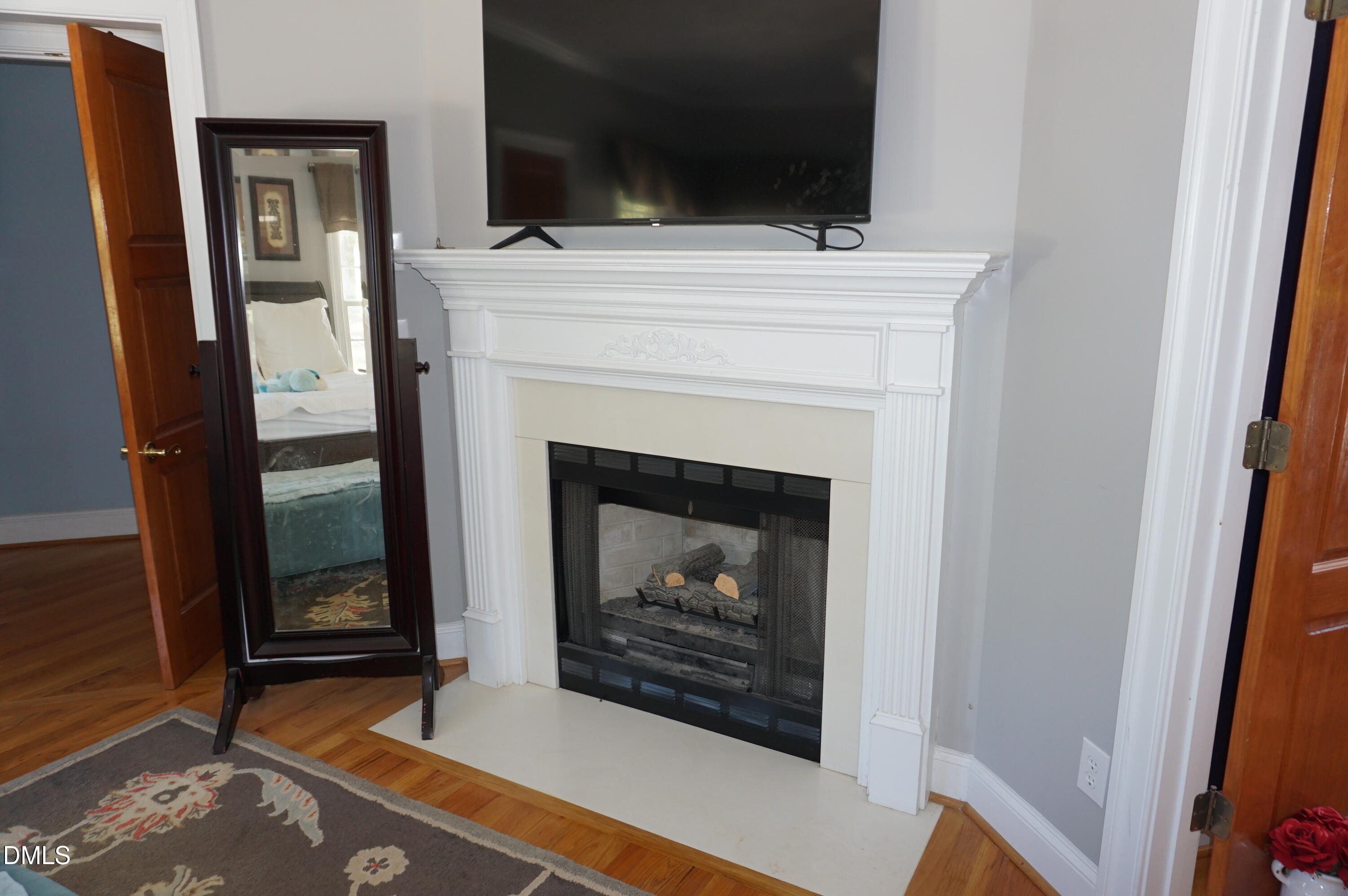 2125 Keith Hills Road Lillington, NC 27546 - Photo 32 of 66 a living room with a fireplace and a flat screen tv