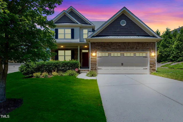 a front view of a house with a yard and garage