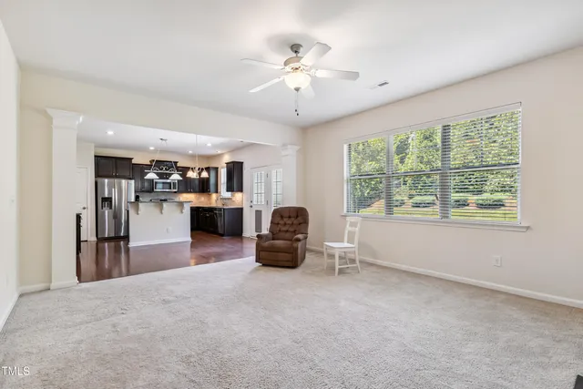 a living room with furniture and a chandelier