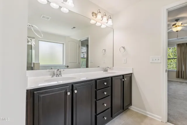a bathroom with a double vanity sink and mirror