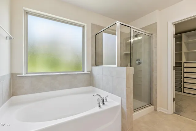 a bathroom with a bathtub and a shower