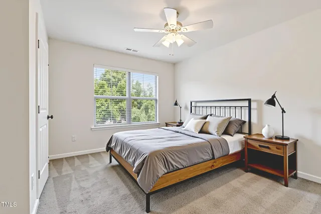 a bedroom with a bed and a ceiling fan