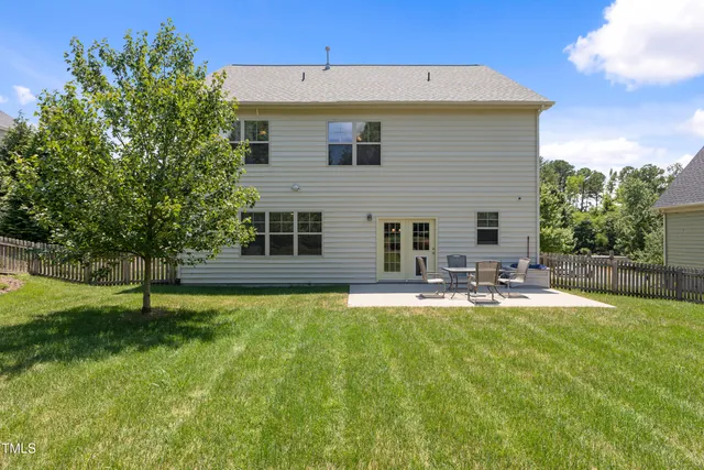 a front view of a house with swimming pool having outdoor seating