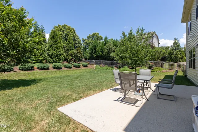 a view of a backyard with sitting area