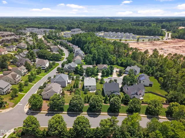 an aerial view of residential houses with outdoor space and street view