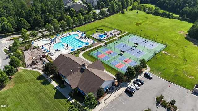 an aerial view of a residential houses with outdoor space and street view