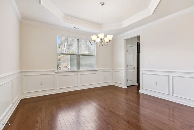 a view of a room with wooden floor and white walls