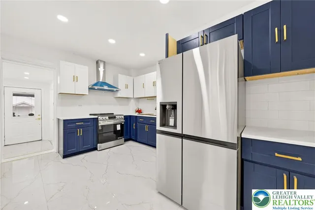 a kitchen with stainless steel appliances granite countertop a refrigerator sink and cabinets