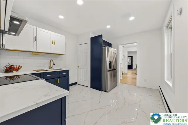 a kitchen with a refrigerator and a sink