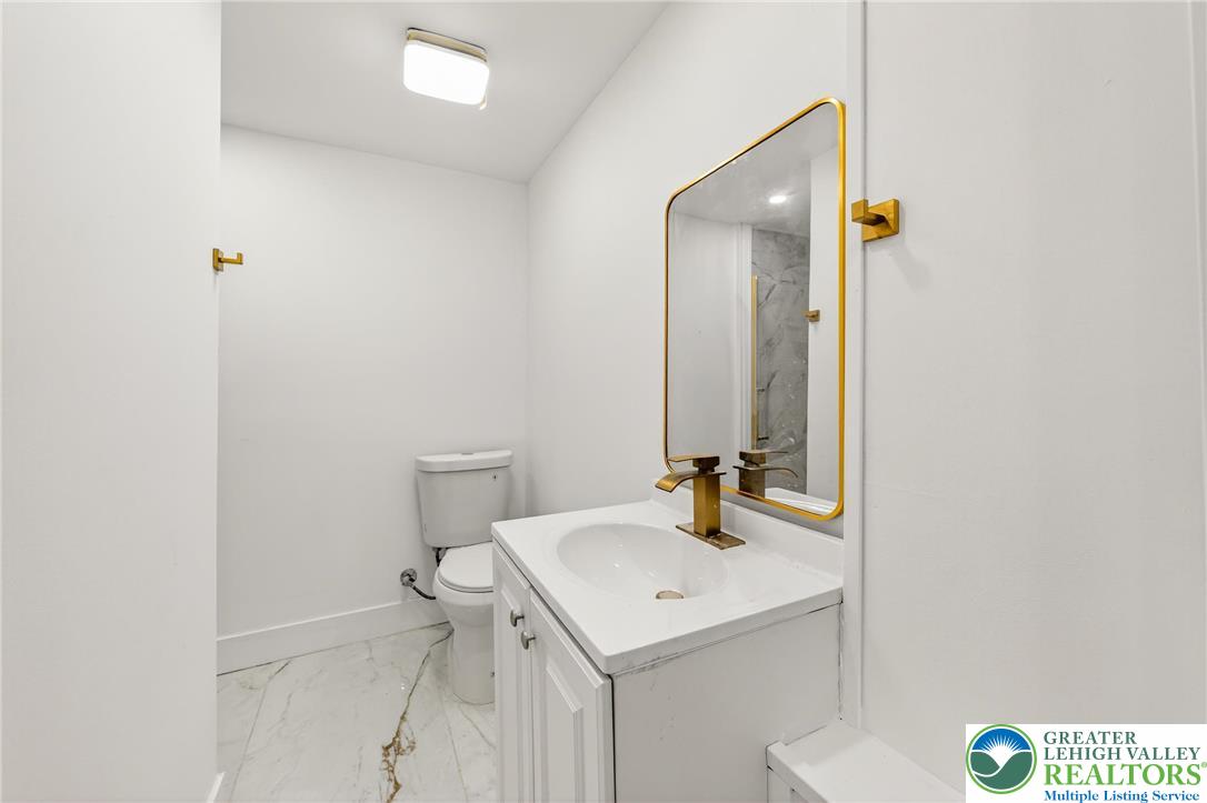 43 Evergreen Street Nazareth, PA 18064 - Photo 16 of 39 a bathroom with a sink a toilet and mirror