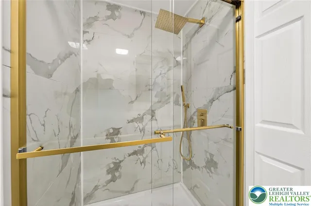 a bathroom with a shower and a sink