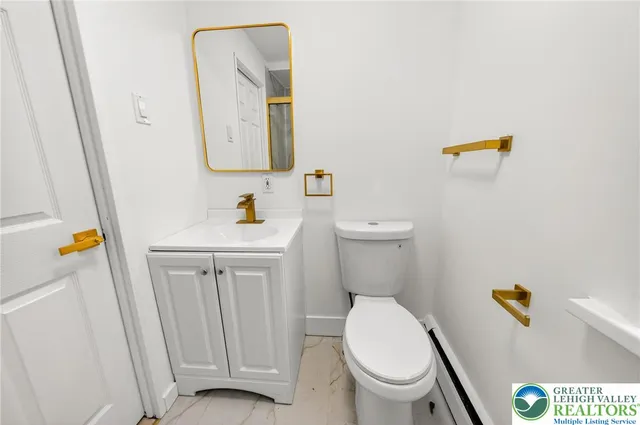 a white toilet sitting next to a bathroom sink