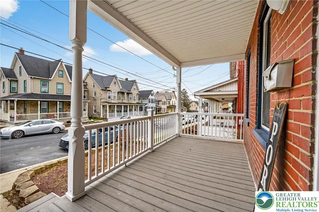 a view of a balcony with wooden floor