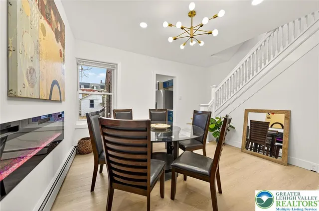 a view of a dining room with furniture and a chandelier